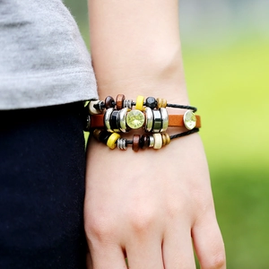 Bohemian multilayer leather bead bracelet with large green rhinestone on a wrist