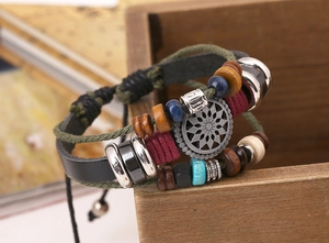 Macro detail of multi-layer boho leather bracelet with sunflower charm and wooden beads