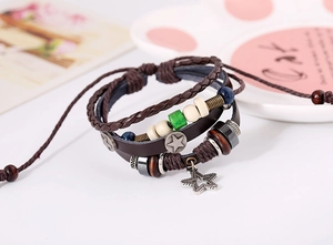 Detail of vintage multilayer leather bracelet with star charms and wooden beads