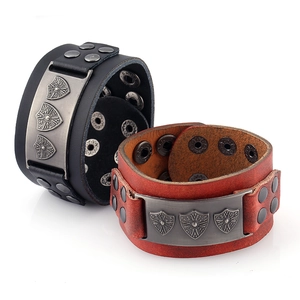 Detail of vintage punk leather bracelets with metal shield plates and rivets