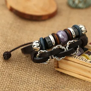 Detail of bohemian multilayer brown leather bracelet with wooden beads and stone accents