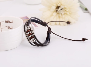 Close-up of vintage multi-layer braided leather bracelet with beads and adjustable cord
