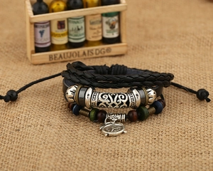 Detail of multilayer leather bracelet featuring a vintage clock charm and colorful beads