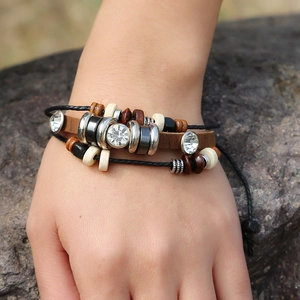 Bracelet multicouche en cuir avec trois zircons blancs et perles de bois porté au poignet