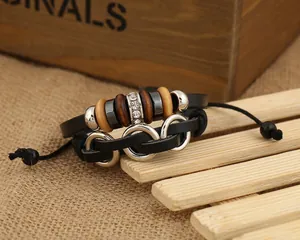 Bracelet multicouche en cuir rétro avec perles en bois et anneaux argentés sur fond rustique