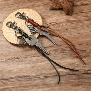 Handcrafted woven vintage leather keychain with retro metal clasp and long fringe tassel