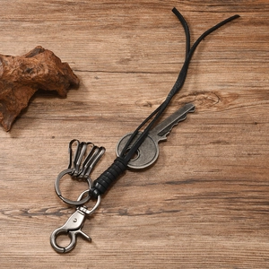 Close-up of retro braided leather keychain with vintage silver alloy rings and key charm