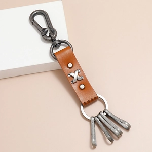 Vintage brown leather keychain with multiple alloy rings and snap hook on a light background