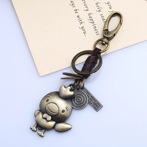 Vintage bronze rooster keychain with brown leather wrap and engraved metal charm tags