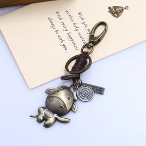 Close-up of a bronze vintage ox leather keychain with metal lobster clasp and engraved tag
