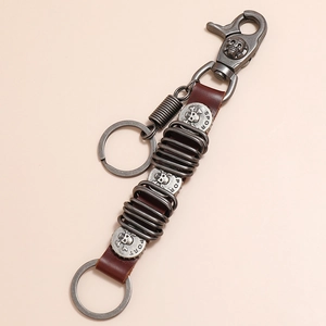 Vintage punk skull keychain with brown leather strap and silver metal spring rings