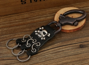 Macro shot of punk style bronze alloy hook with leather base and silver skull detail