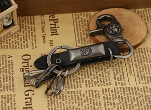 Close-up of leather keychain featuring a vintage lion crest and skull embossed clasp