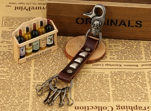 Detail of punk leather keychain with metal studs and skull embossed spring hook