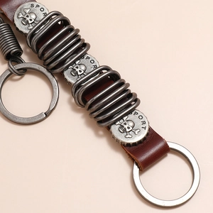 Macro view of punk skull leather keychain with antique silver metal coils and rings