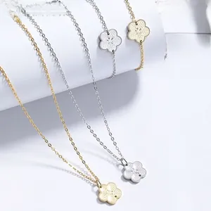 Detailed view of floral pendant necklace and bracelet sets in gold and silver finishes