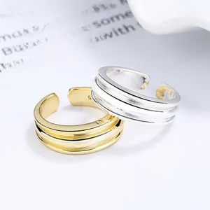 Detail of silver and gold plated S925 sterling silver triple layer open rings with 925 hallmarks