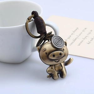 Retro brass pig keychain with genuine leather wrap on a classic metallic ring