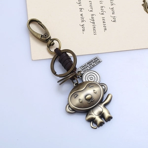 Detail of vintage bronze monkey zodiac keychain with leather wrap and engraved metal tags