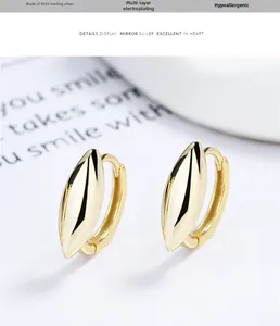 Macro view of polished S925 sterling silver hoop earrings with marquise sharp edges