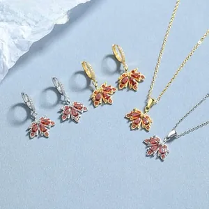 Macro detail of maple leaf jewelry set with brown zircon stones and gold finish