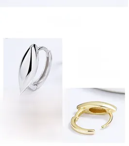Detail of 925 sterling silver hoop earrings in silver and gold hand-polished finishes