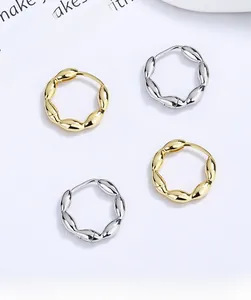 Close-up of twisted rope texture on S925 sterling silver hoop earrings in gold and silver