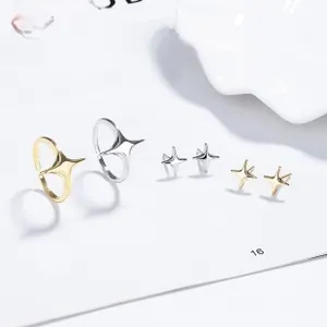 Detail of star-shaped adjustable rings and matching stud earrings on a magazine page