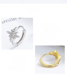 Detailed close-up of 925 sterling silver star hoop earrings in silver and gold finishes