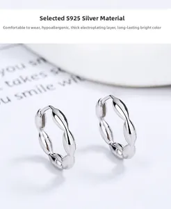 Detailed view of 925 sterling silver twist hoop earrings with high polish wavy design
