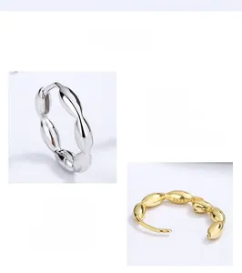 Detailed close-up of S925 sterling silver twist hoop earrings with wavy textured finish
