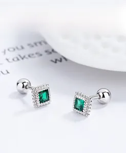 Macro view of 925 silver emerald square screw-back studs with sparkling bead borders