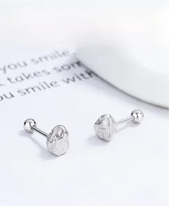 Macro shot of S925 sterling silver screw back earrings with irregular rock texture detail