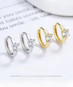 Macro shot of 925 sterling silver six-claw stud earrings with sparkling cubic zirconia