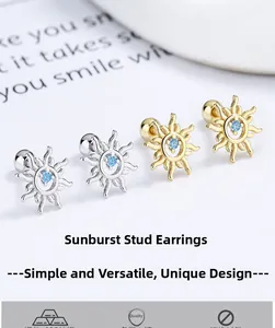 Detailed view of 925 silver sun stud earrings with blue zircon in gold and silver