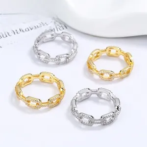 Close-up of gold and silver chain rings with sparkling micro-pave zircons set on white