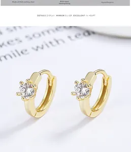Macro shot of 925 silver gold-plated hoop earrings with brilliant-cut cubic zirconia