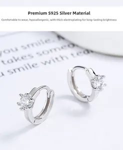 Detailed macro view of S925 sterling silver hoop earrings with six-prong set cubic zirconia