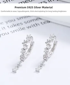 Detail of 925 sterling silver drop earrings featuring sparkling zircon stone pavé setting