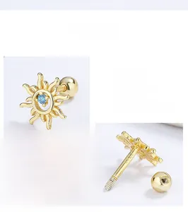 Macro shot of 925 sterling silver sunflower earring with blue gemstone and screw back