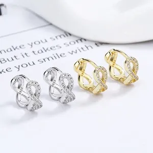 Detail of S925 sterling silver infinity hoop earrings set with sparkling zircon stones