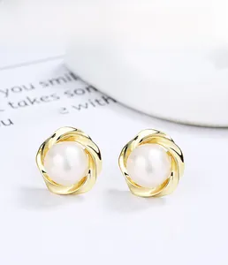 Close-up of S925 silver pearl earrings with twisted gold-plated metal wire details