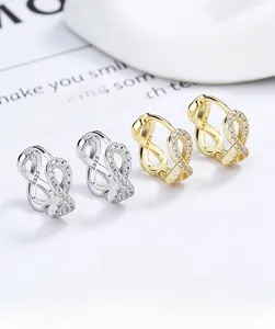 Detailed view of S925 sterling silver infinity earrings with paved cubic zirconia