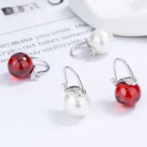 Classic silver earrings featuring deep red resin beads and white faux pearls in J-hook design