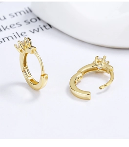 Detail of 925 sterling silver gold-plated hoop earrings with sparkling round zircon studs