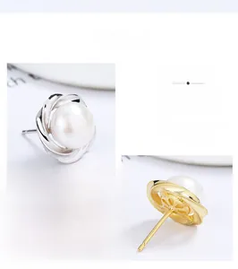 Detailed view of sterling silver petal earrings with freshwater pearls in gold and silver