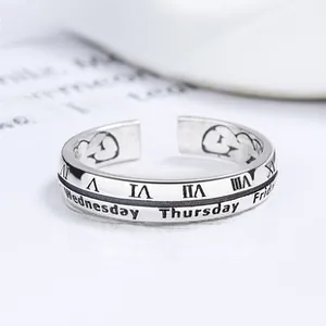 Close-up of vintage 925 silver ring featuring Roman numerals and days of the week engraving