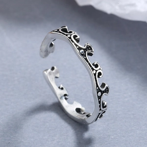 Close-up of vintage 925 sterling silver adjustable ring with wavy oxidized patterns
