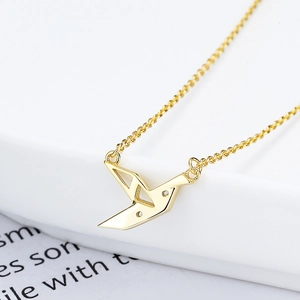 Elegant 925 sterling silver gold origami paper crane necklace on white tray background