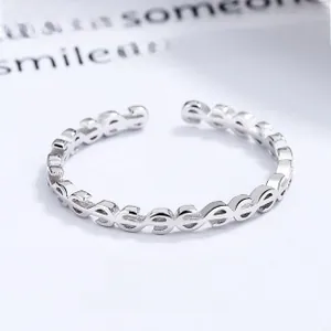 Detailed view of 925 sterling silver ring with dollar sign patterns and open adjustable band